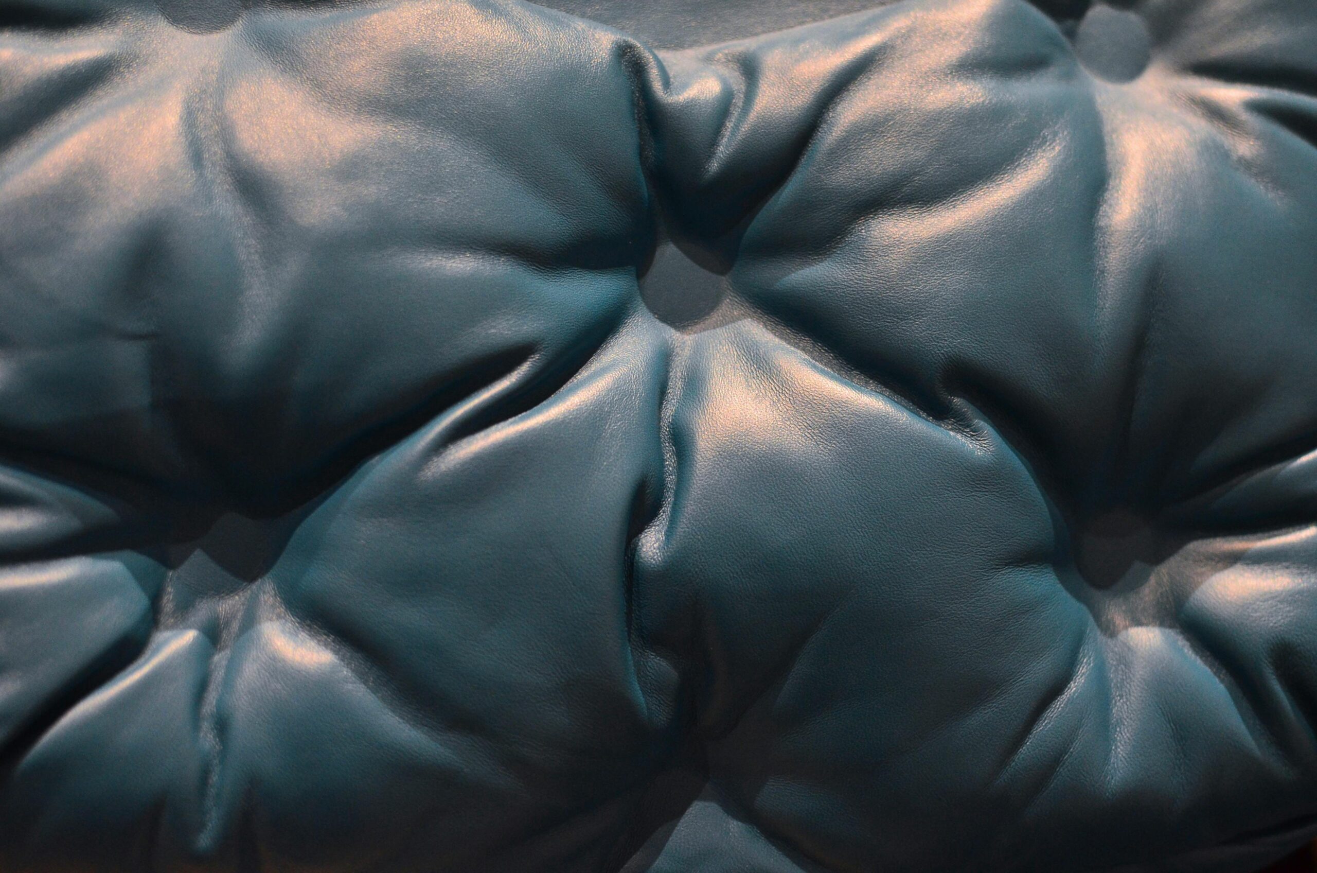 Learn how to clean a leather couch with these items to get rid of stains. Pictured: A blue leather couch