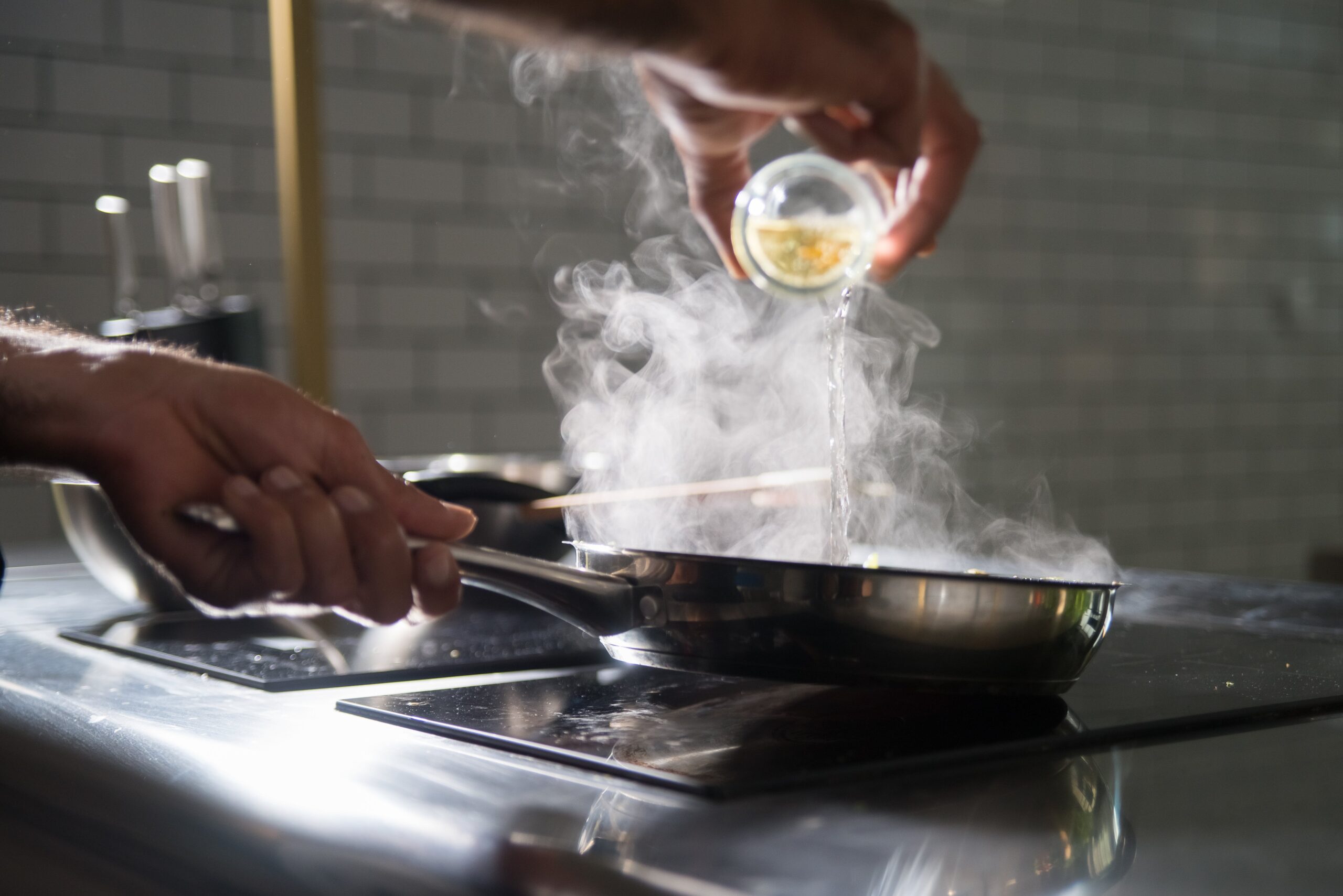 A person cooking on an electric stove