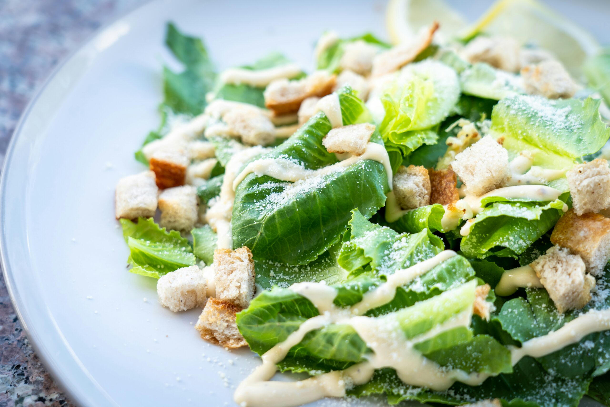 A caesar salad is the perfect starter course in your Valentine's Day dinner idea. Pictured: A caesar salad.