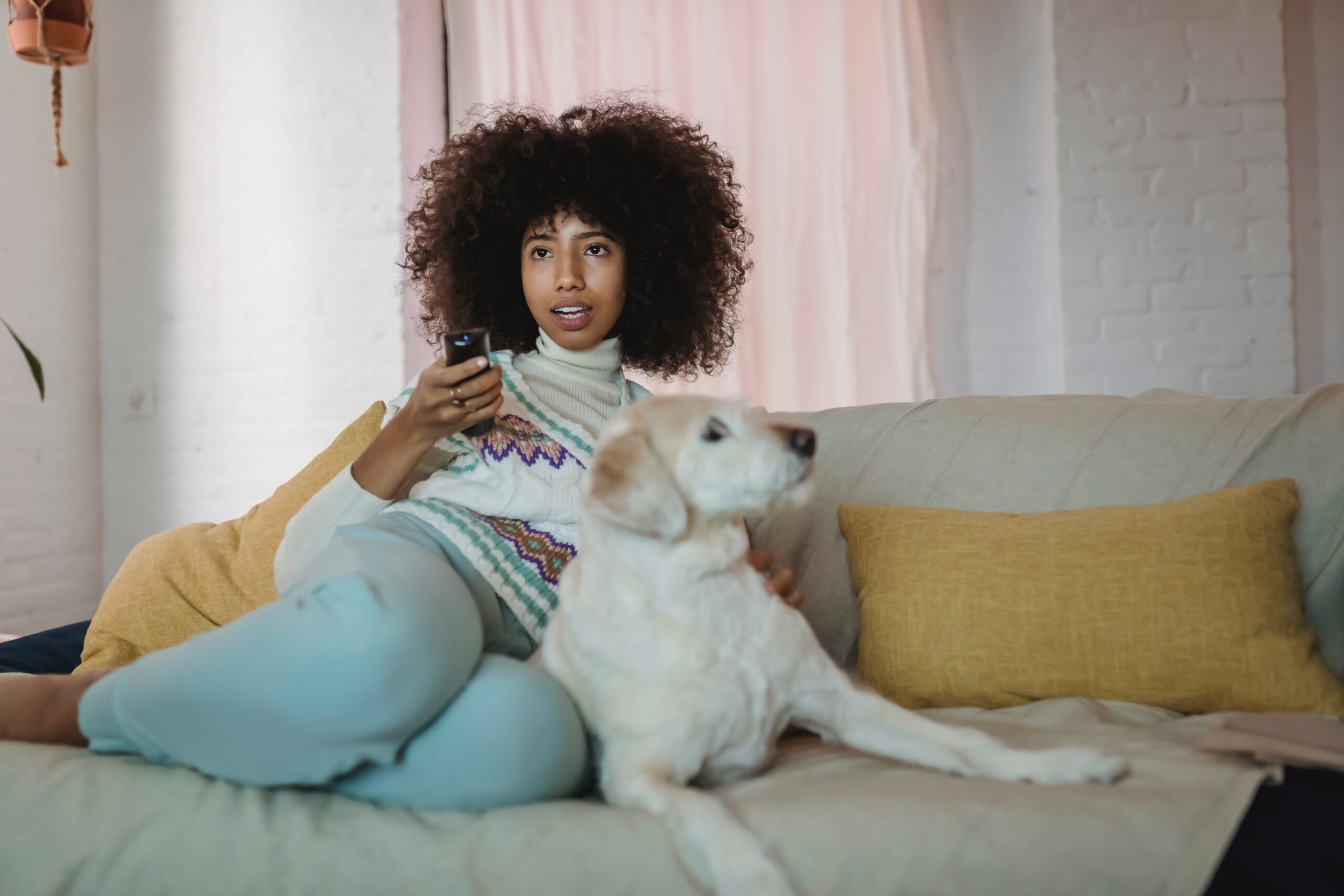 woman watching TV on sofa