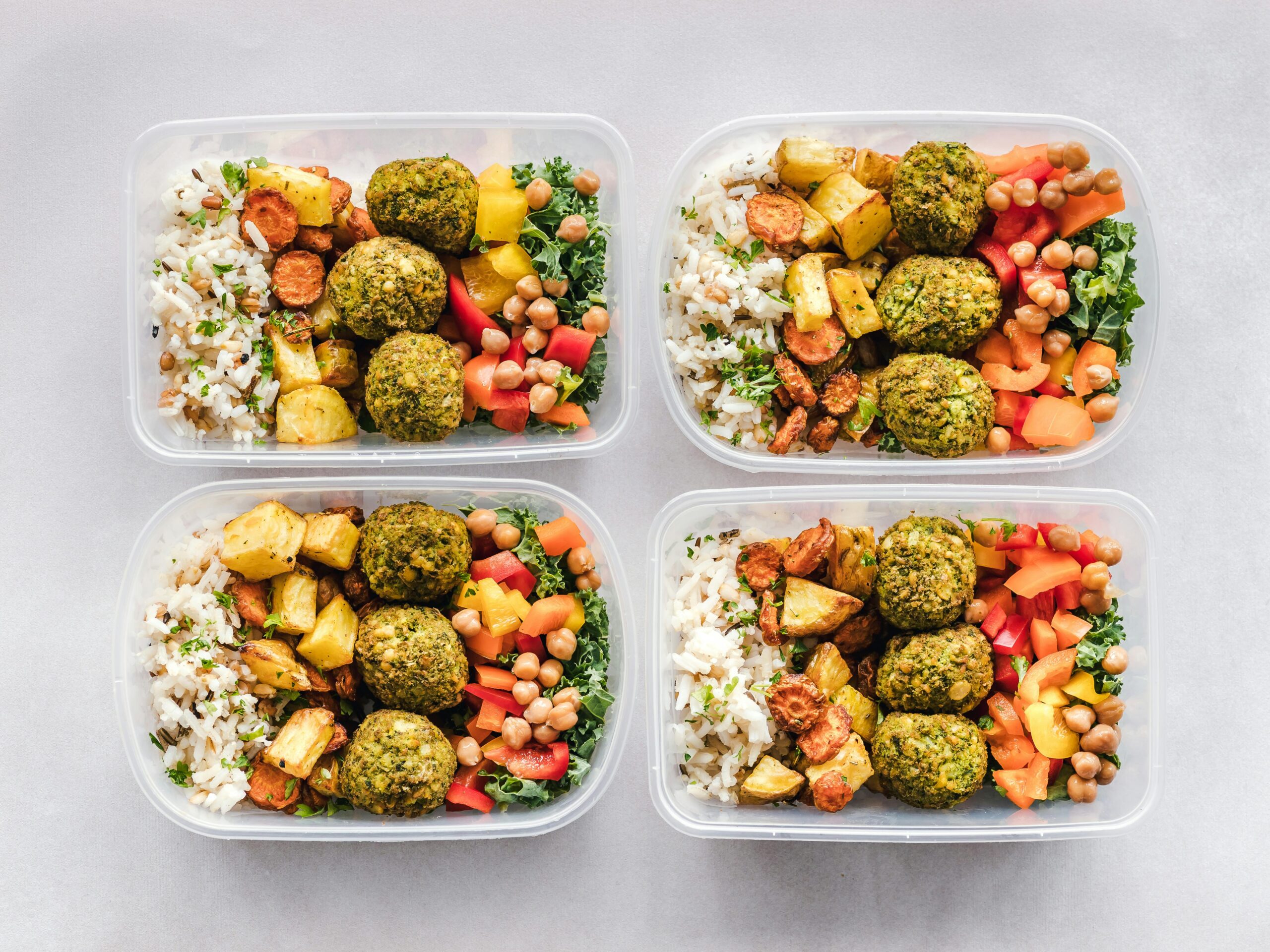 Four prepared meals in containers