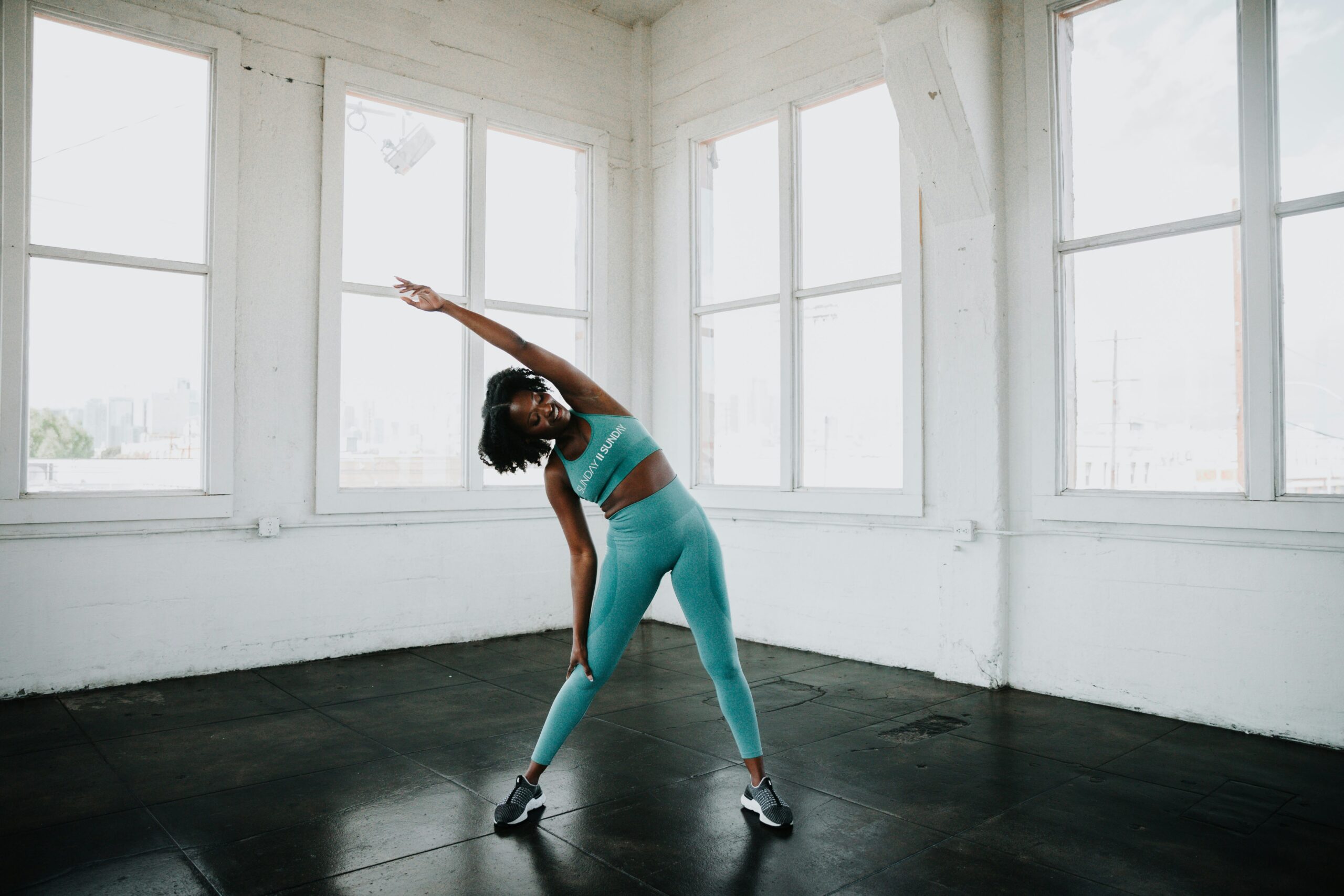 For fitness, dance and pilates, follow this at home instructor on Youtube: Pictured: A Black woman exercising