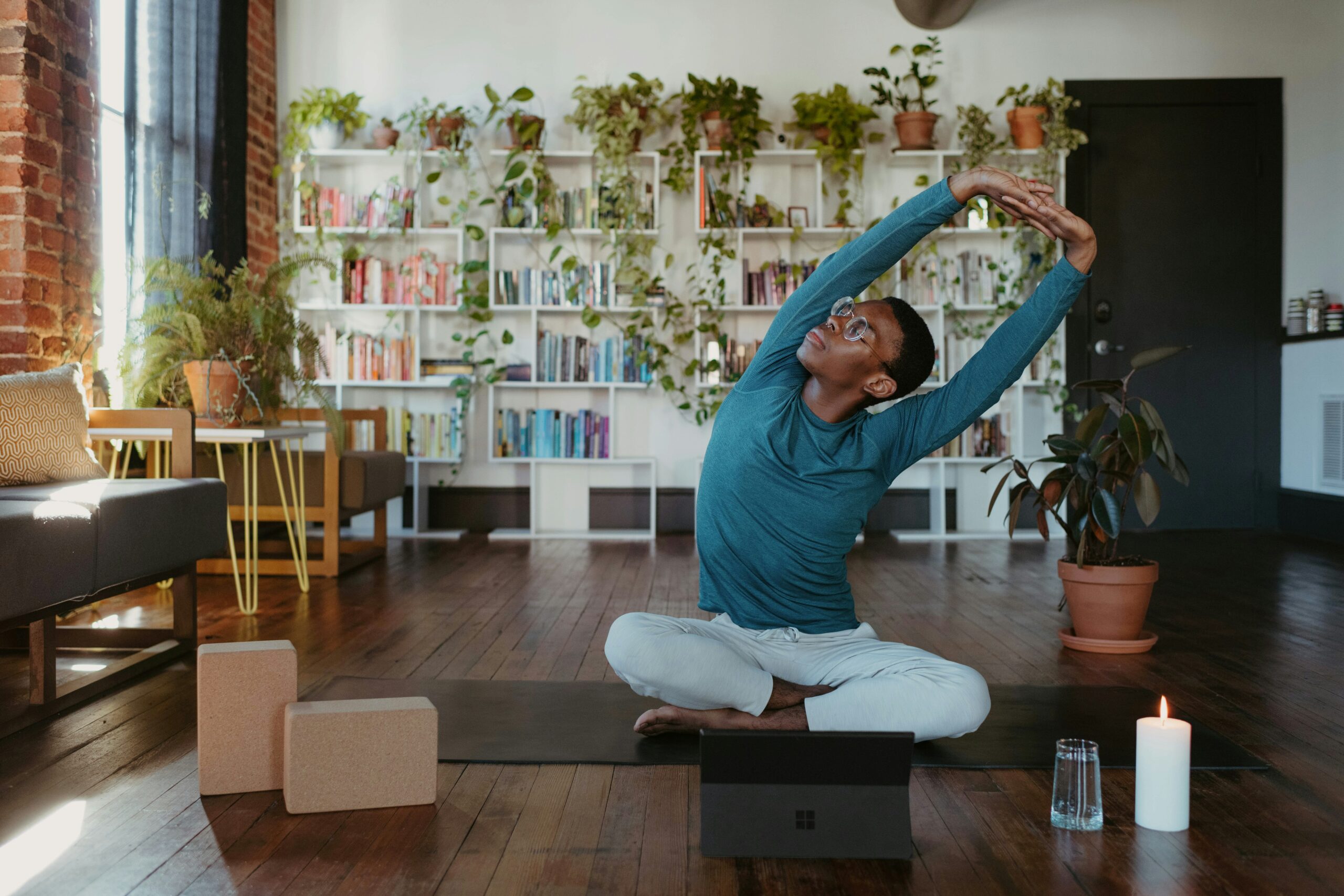 A man doing a yoga pose on a floor mat