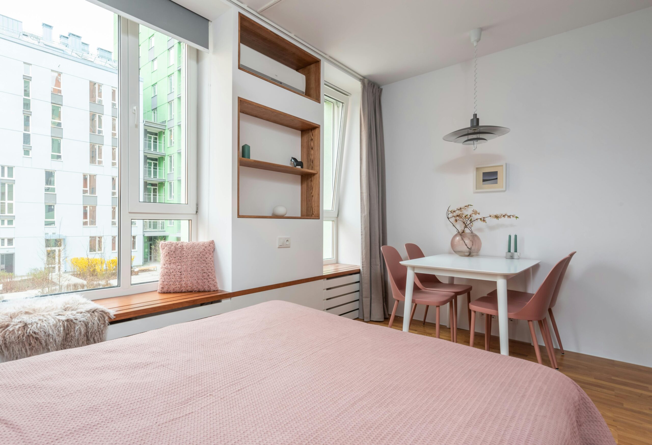A bedroom with light pink decor