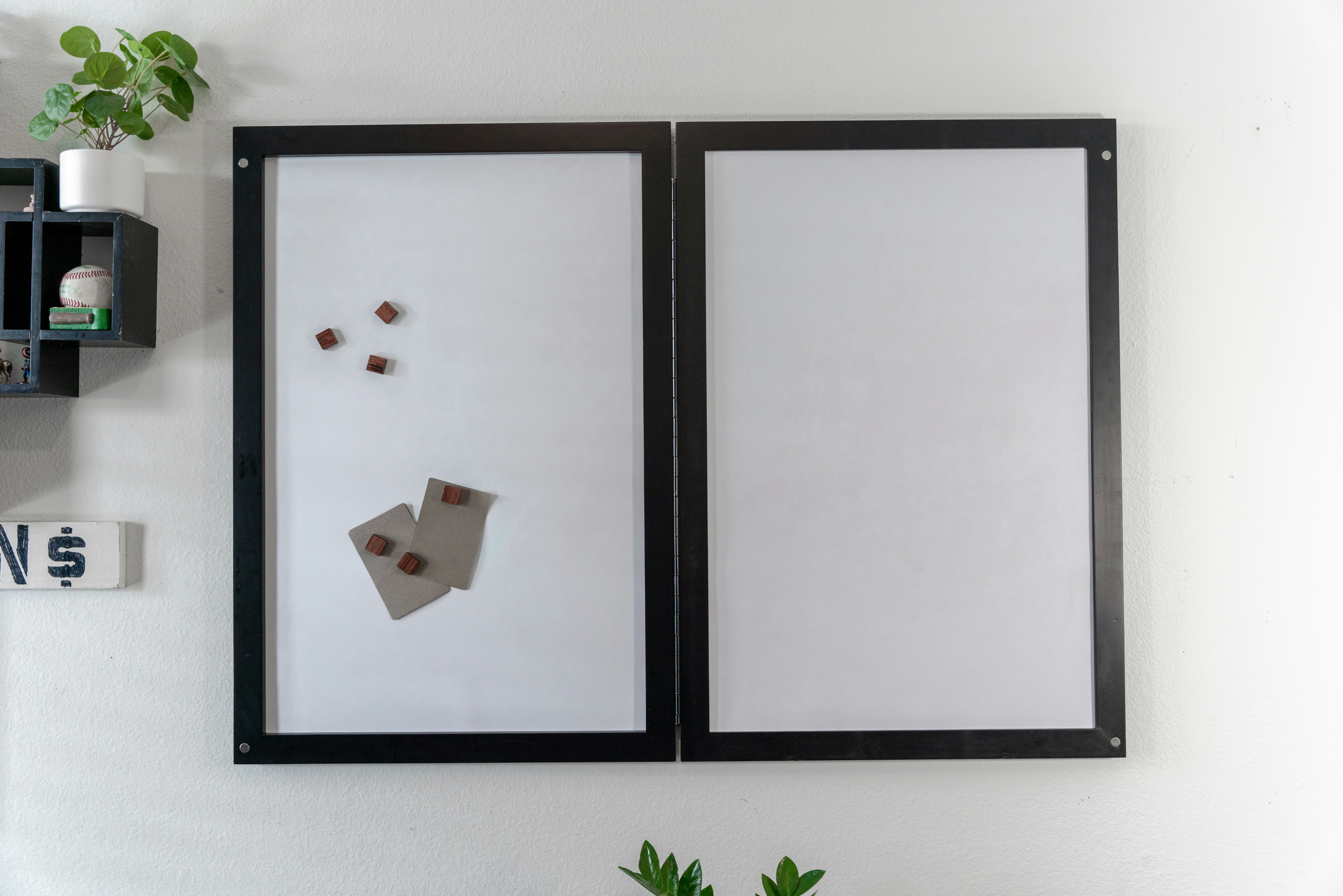 A dry erase board mounted on a white wall