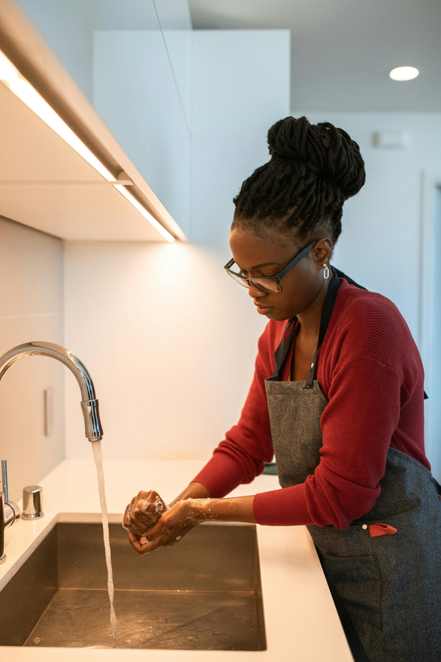 Woman washing in sink