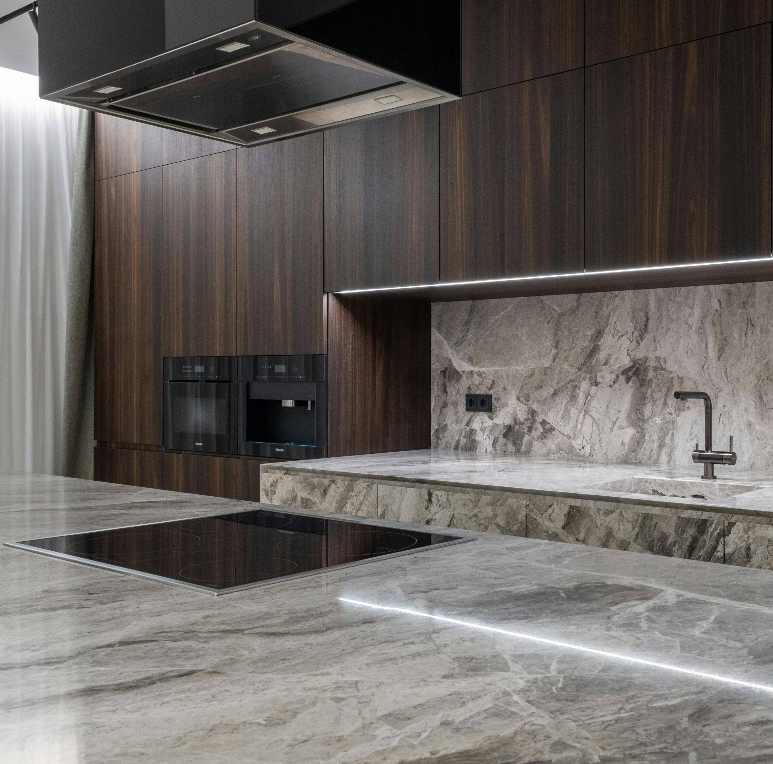 A stylish modern kitchen with marble countertops