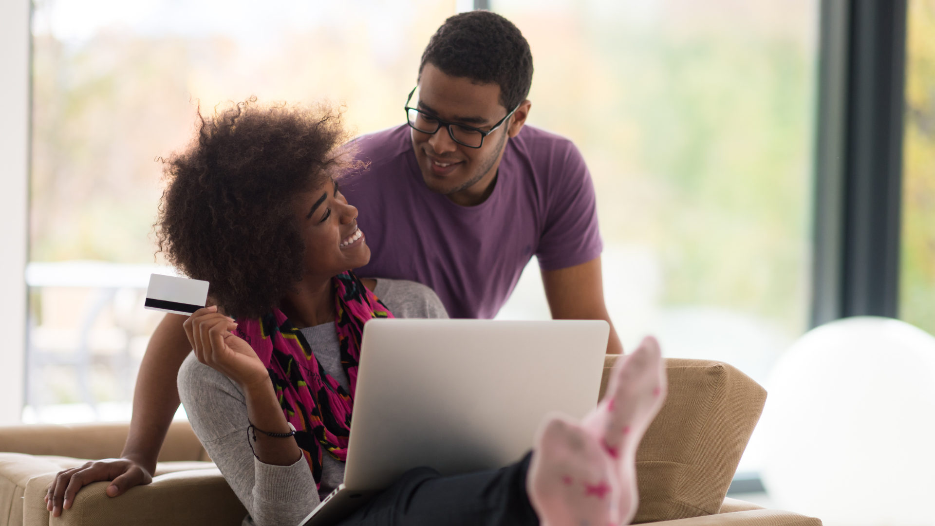 African American Couple Shopping Online looking at furniture for cheap in their new home