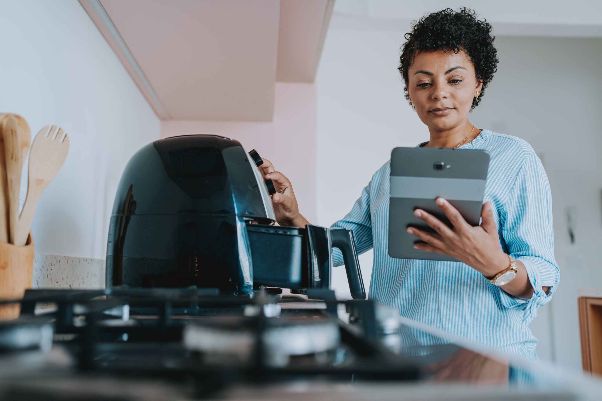 woman using air fryer