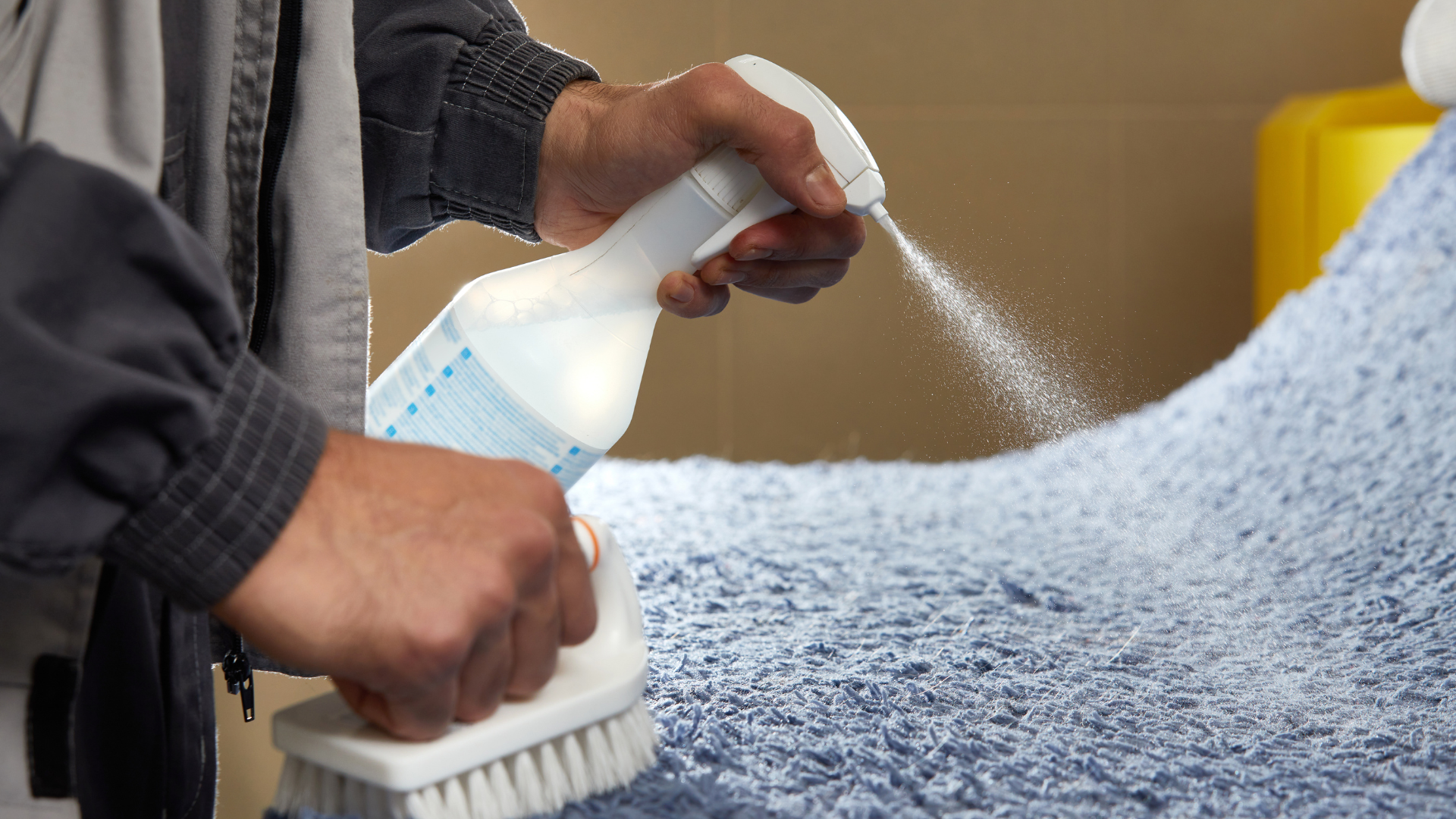 Man Using Spray to Remove Stain from Carpet in Carpet Cleaning Service⁠