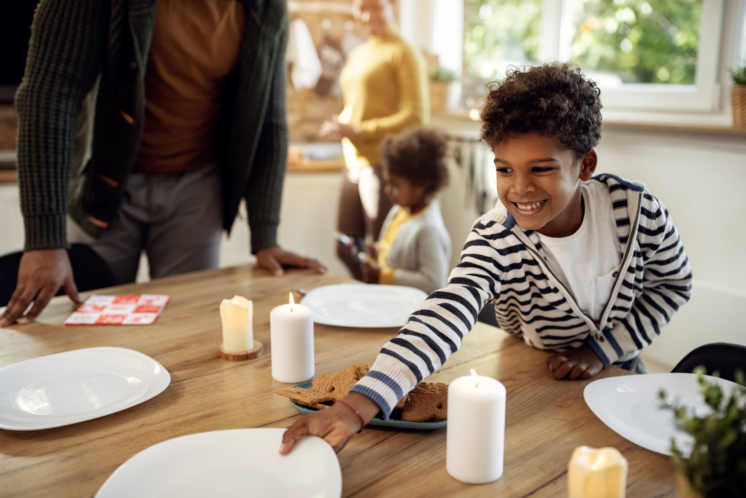 Child helping to set table