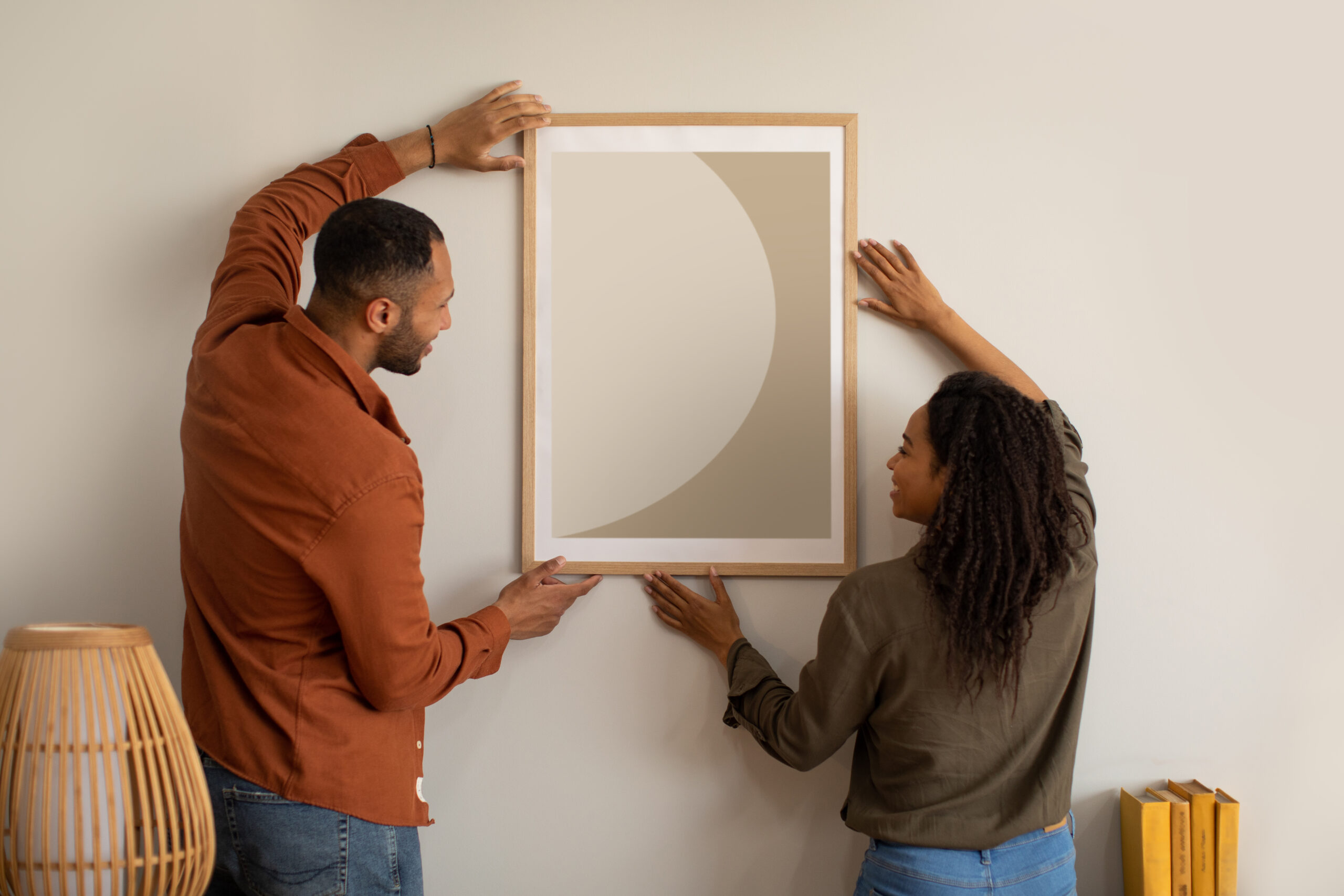 couple putting up artwork