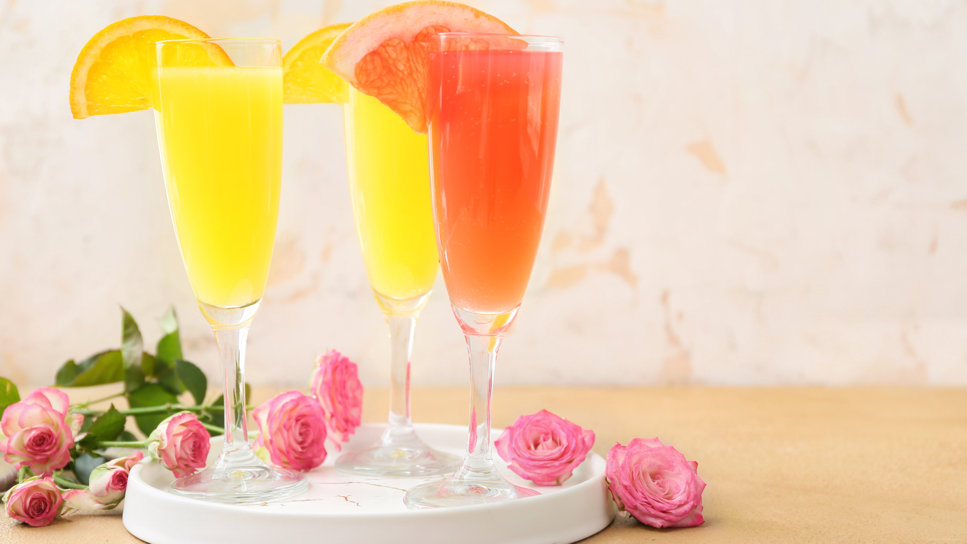 Glasses of Mimosa Cocktail on Table with flowers