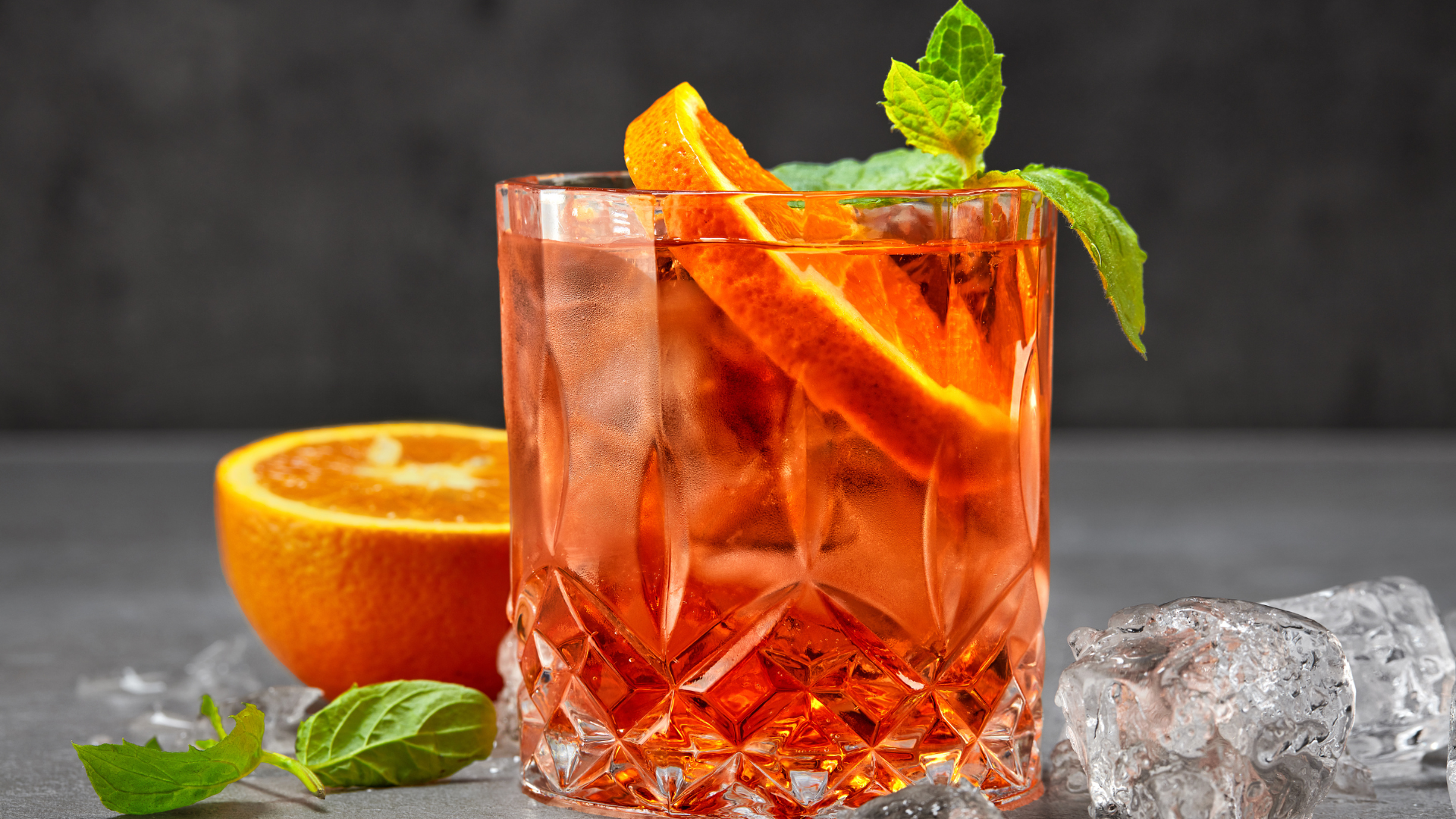 Italian cocktail Aperol Spritz surrounded by its ingredients