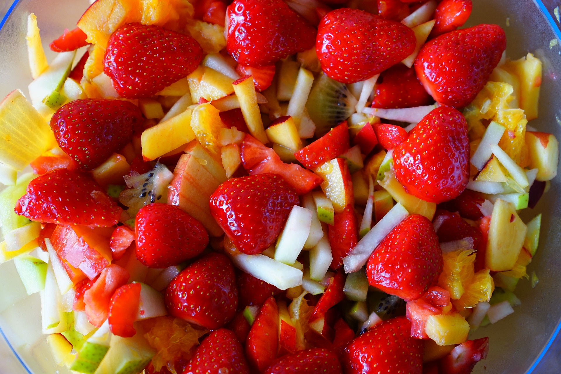 Strawberries and apples on top of a salad