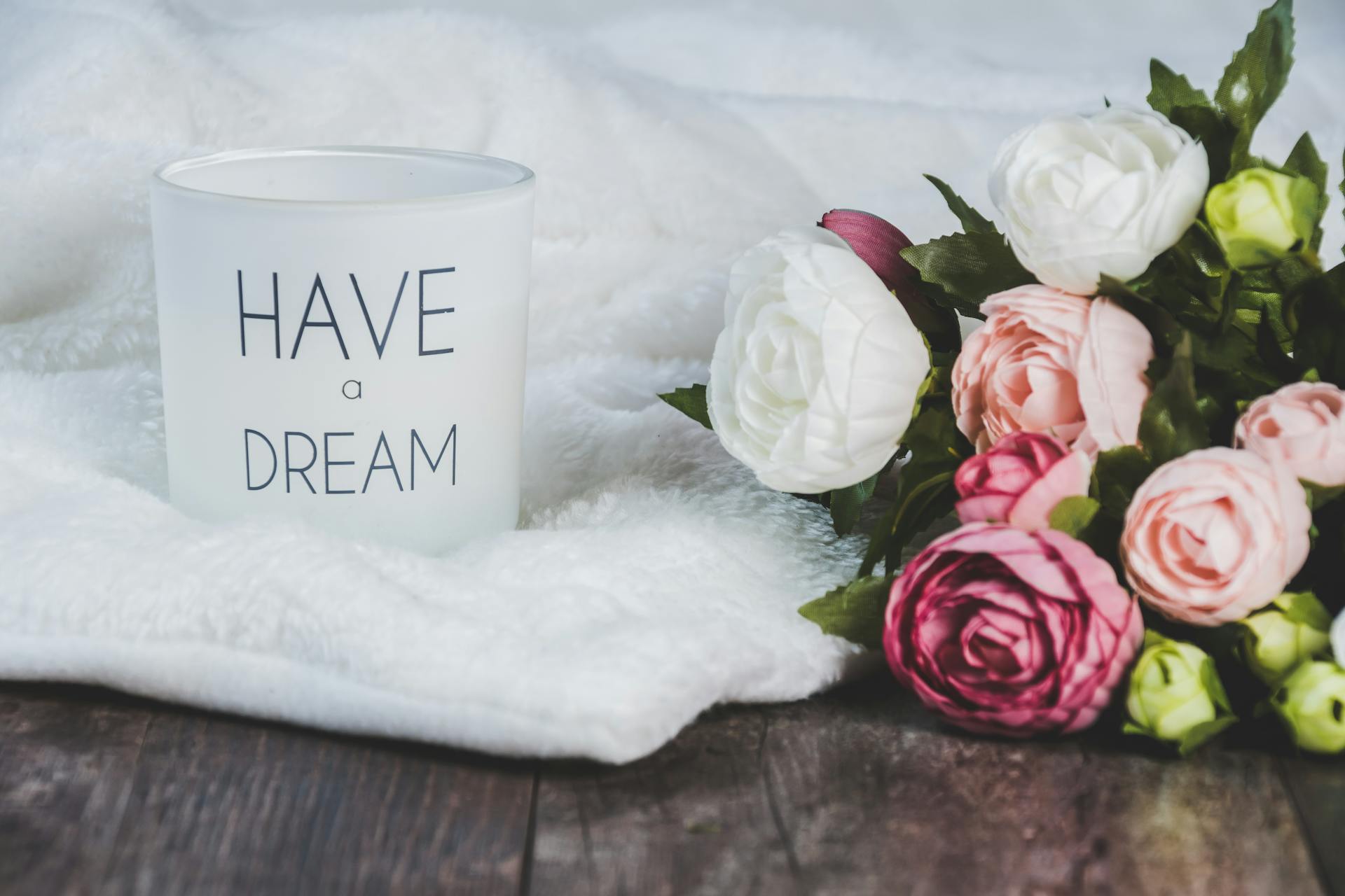 Have a Dream mug next to a bouquet of flowers