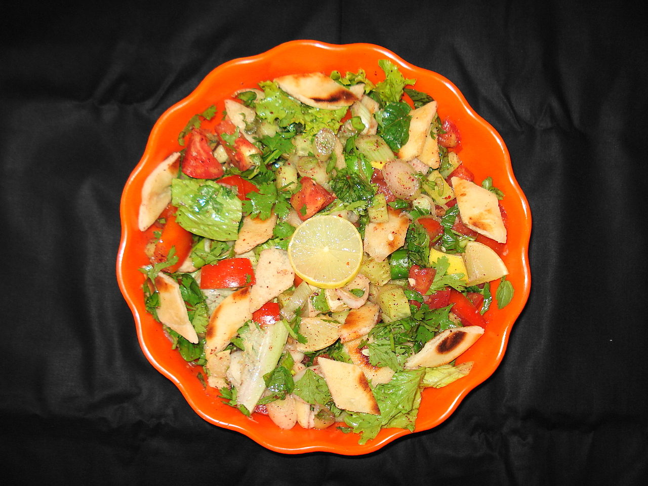 Fattoush salad in an orange plate
