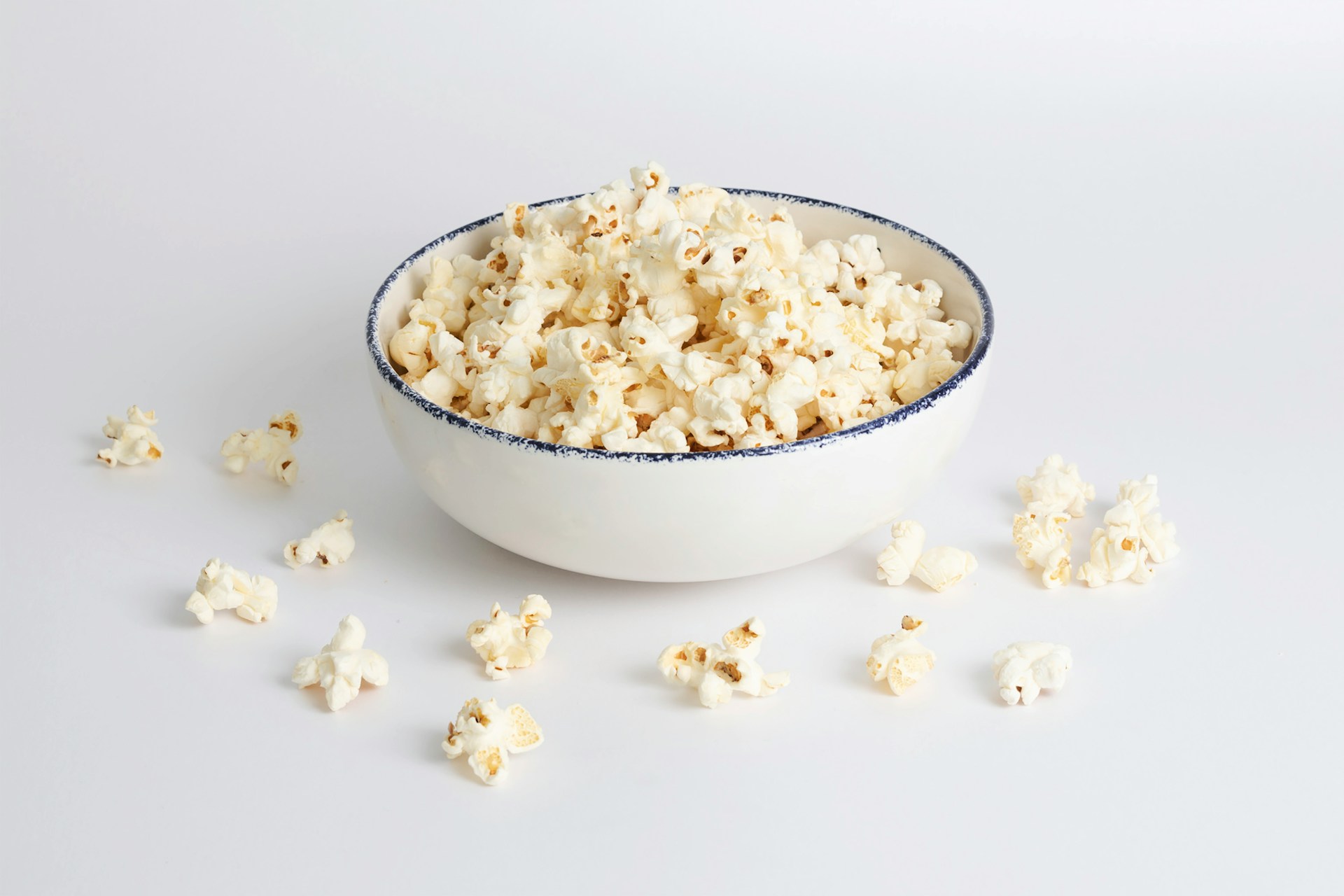 Popcorn in a white bowl with blue lining