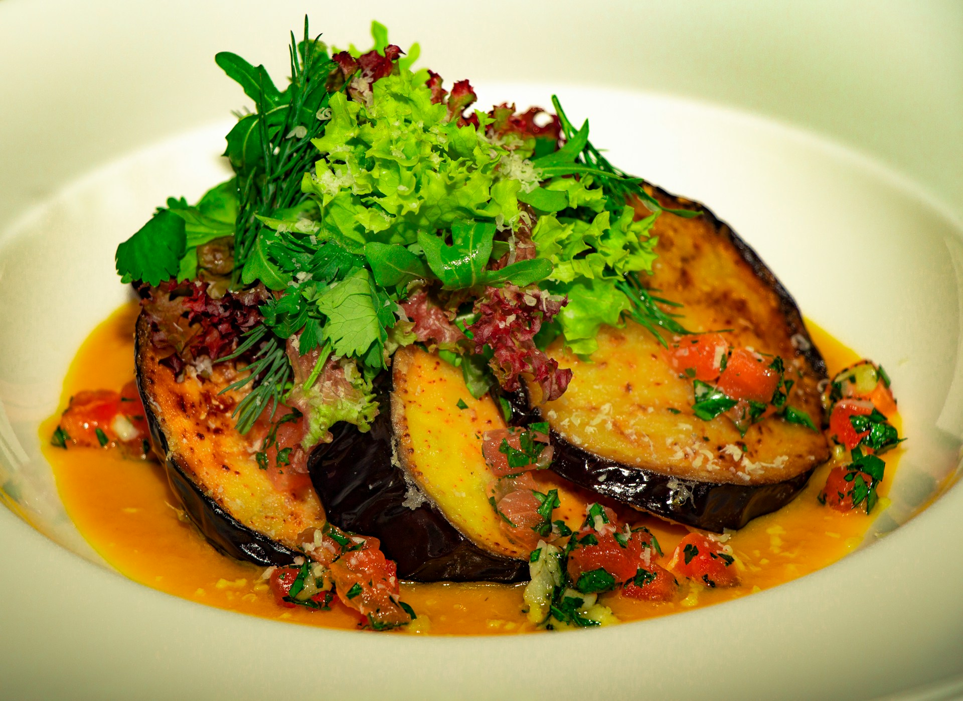 Eggplant parmesan with vegetables on a plate