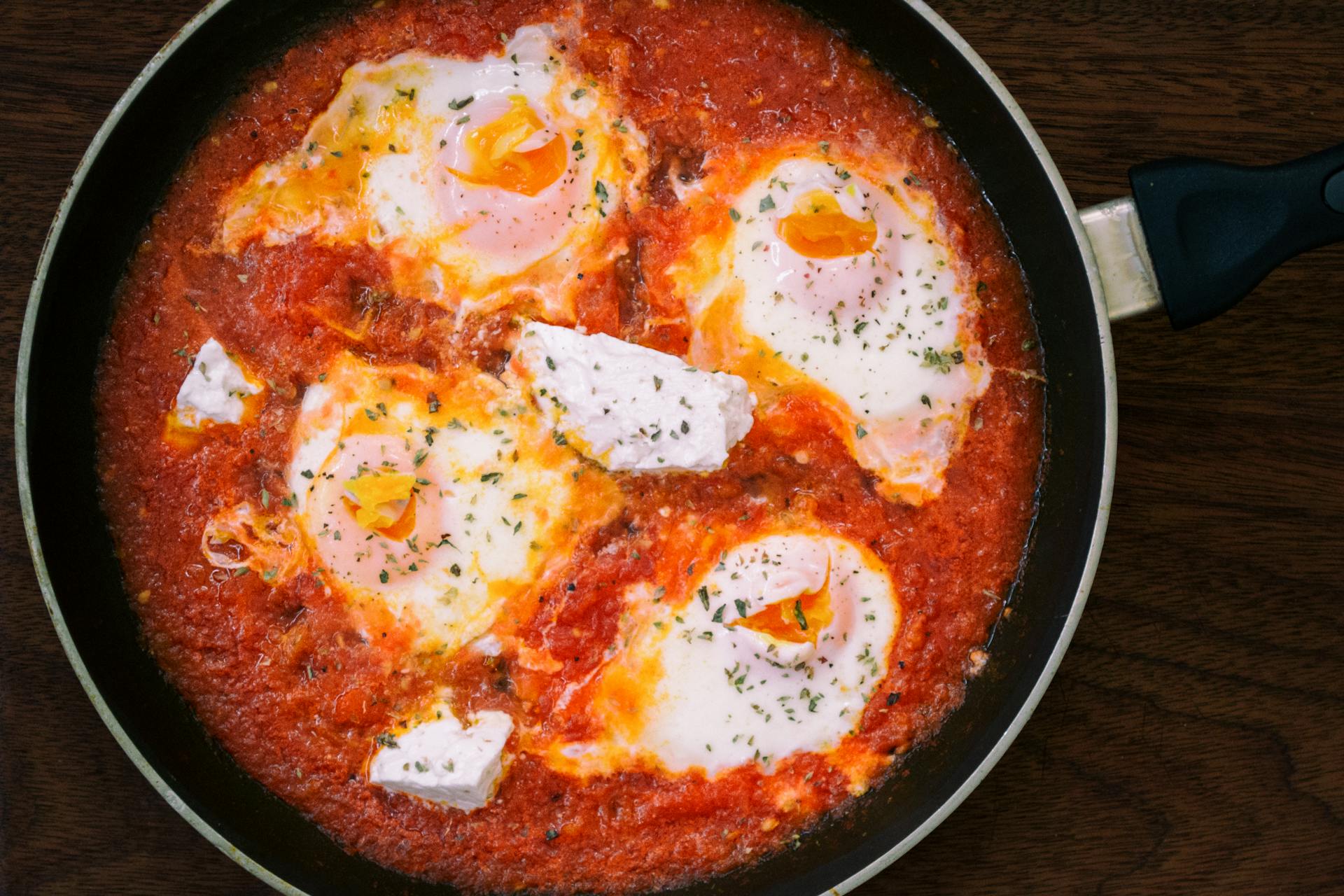 Eggs with red tomato sauce in a pot