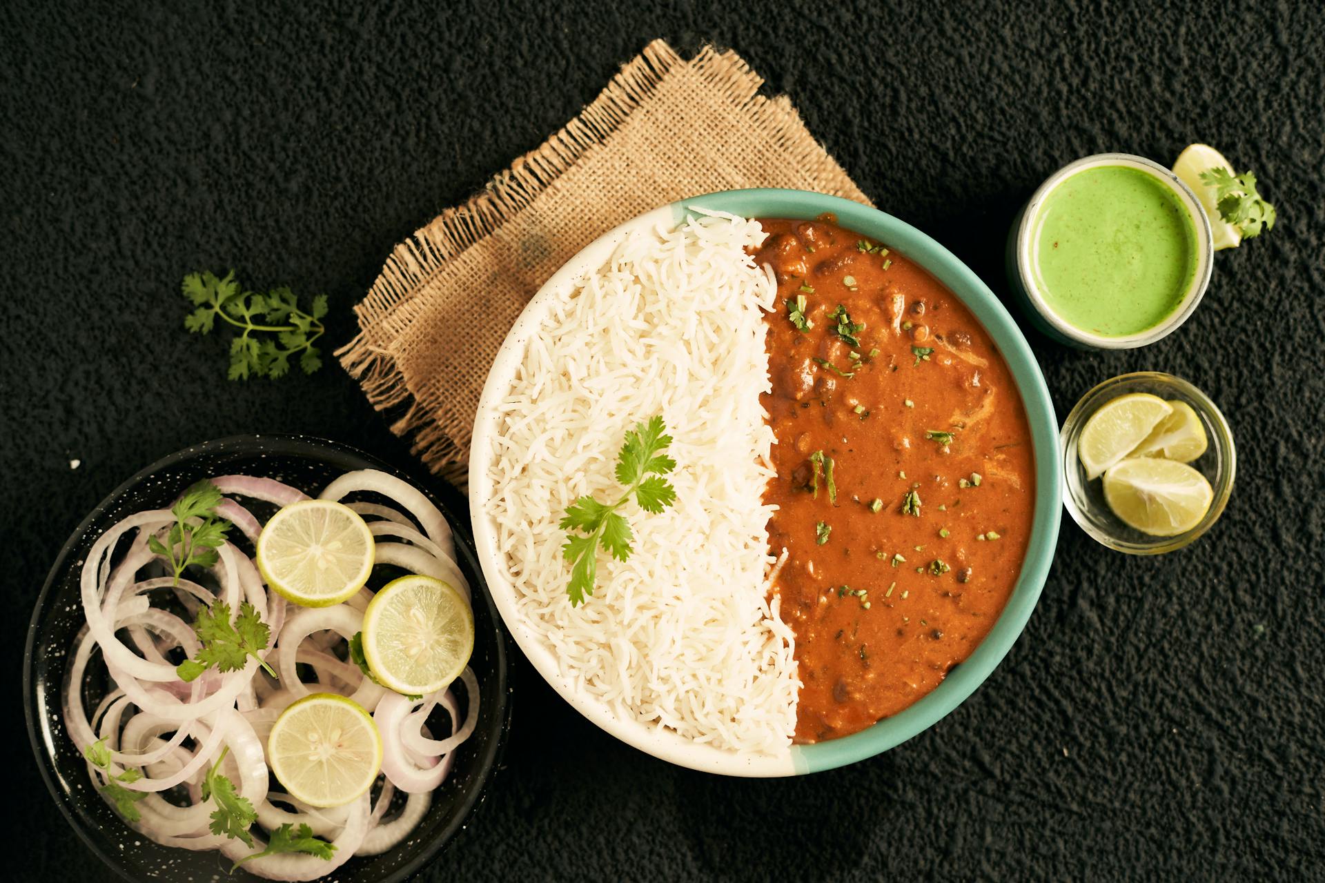 Cooked white rice on one side of bowl with lentil soup on the other