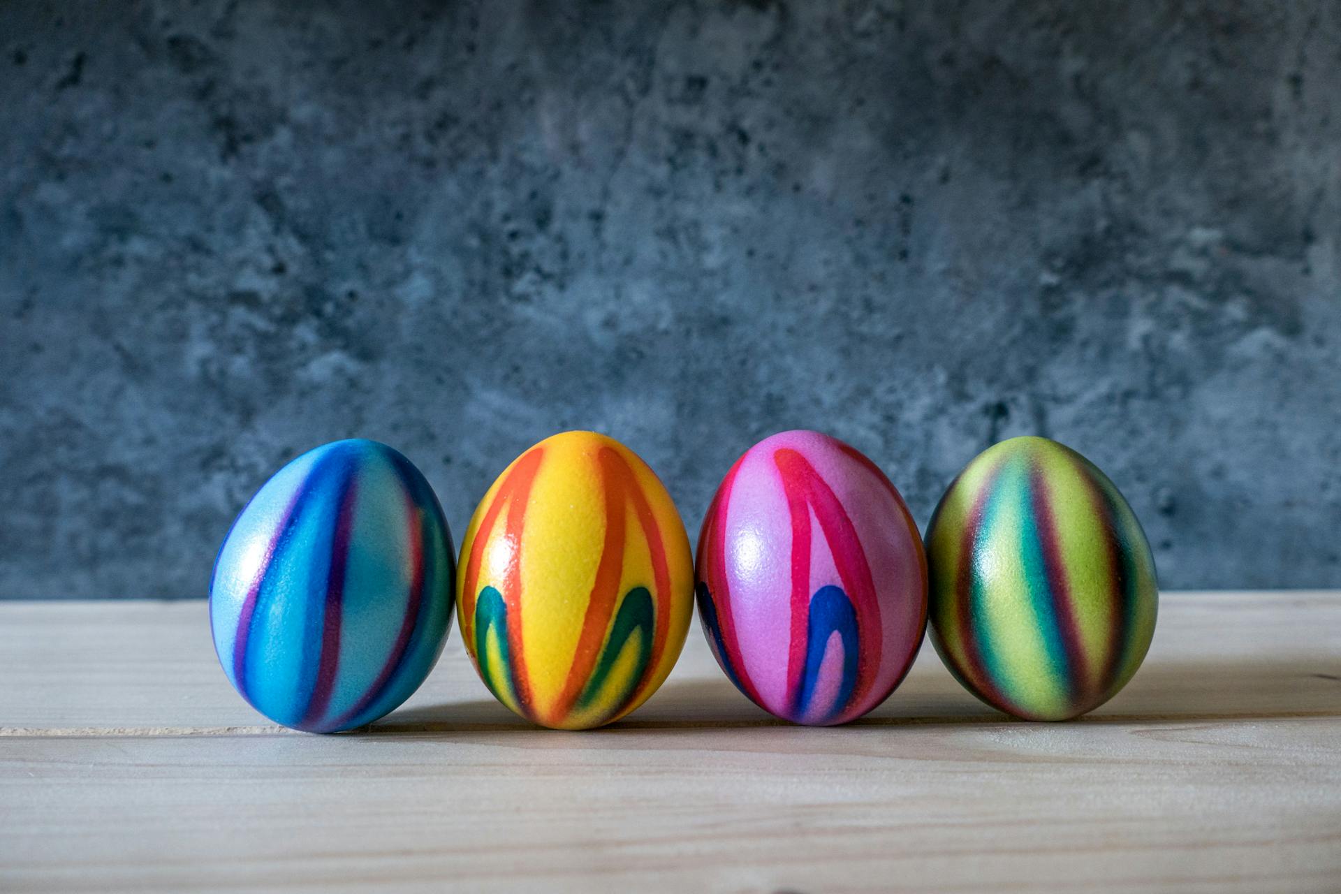 Colorfully dyed eggs in blue, yellow, orange, pink, green and purple