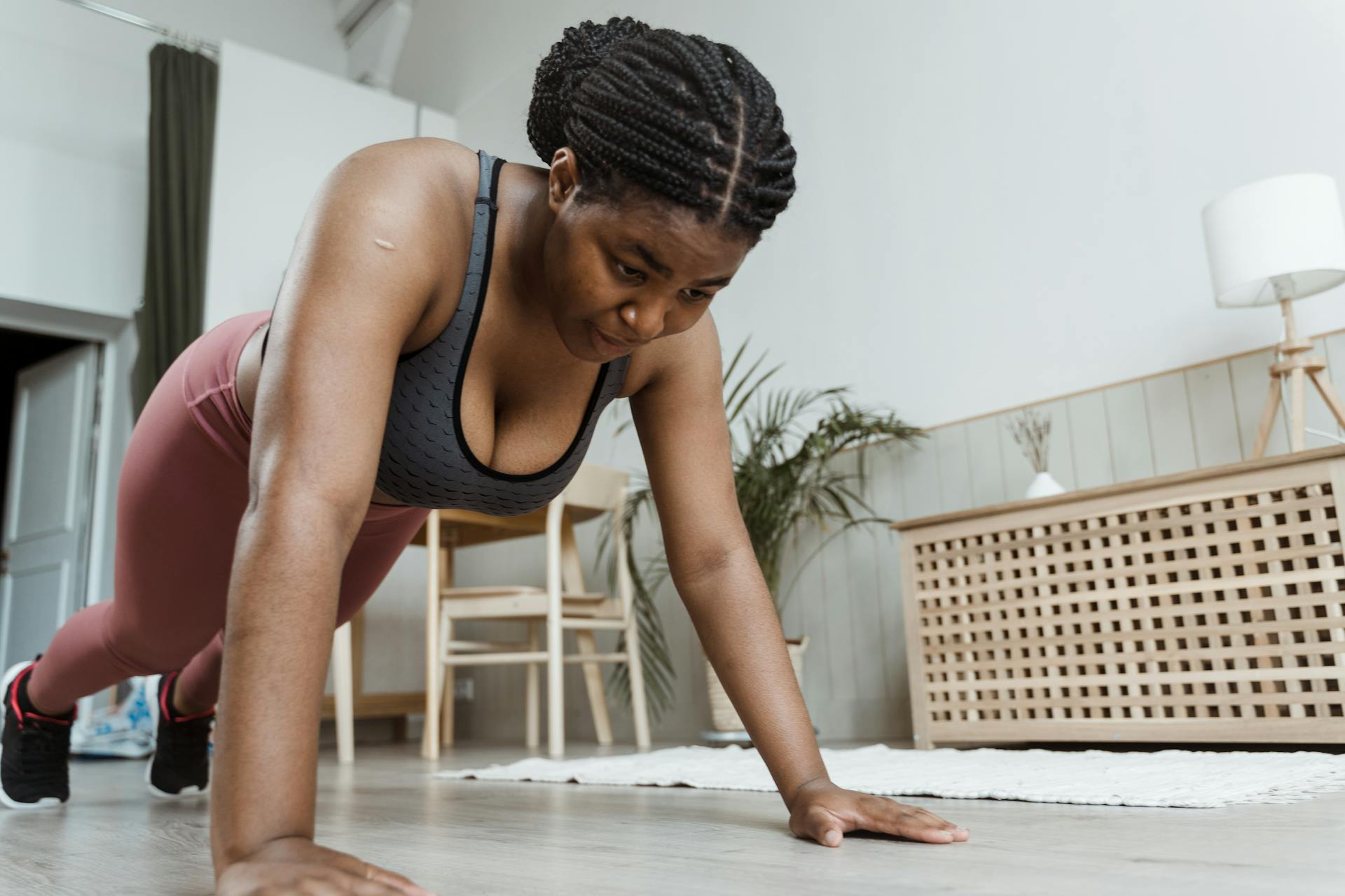 Woman positions herself into a plank