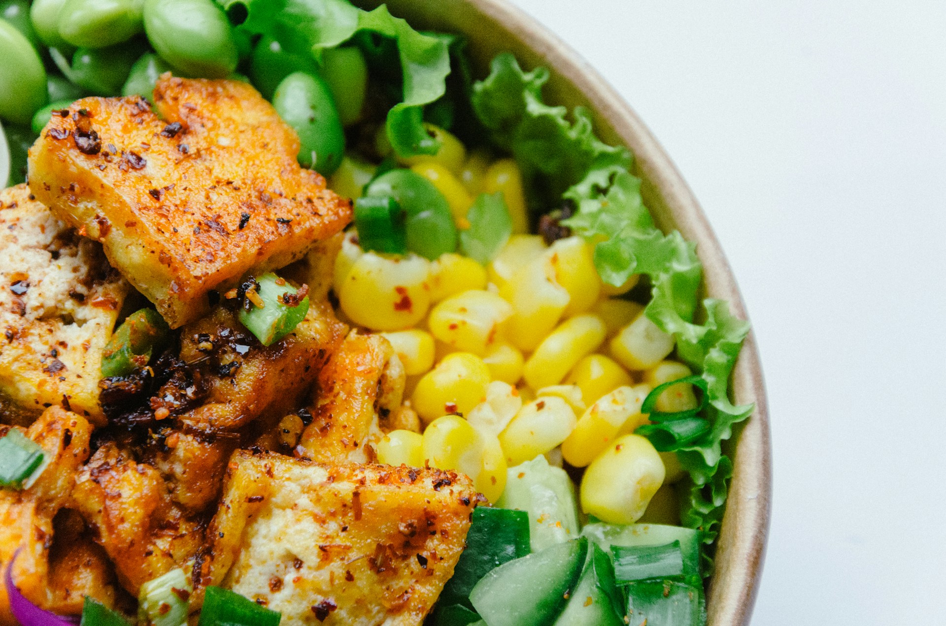 Tofu, corn and edamame on top of lettuce