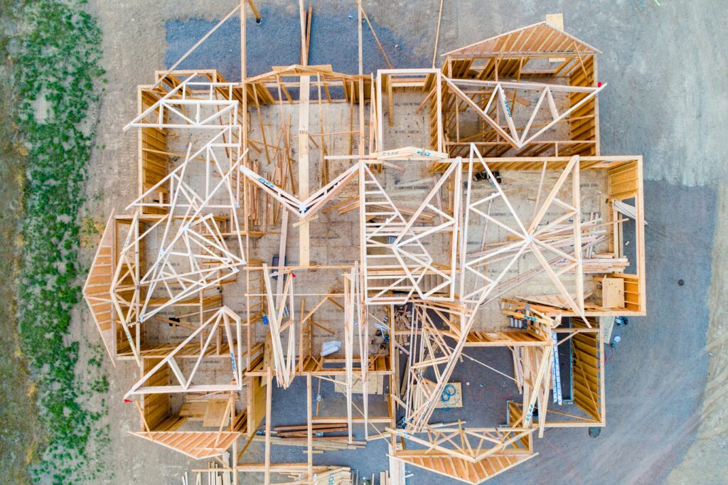 An overhead shot of a house being built with just the wood frame constructed