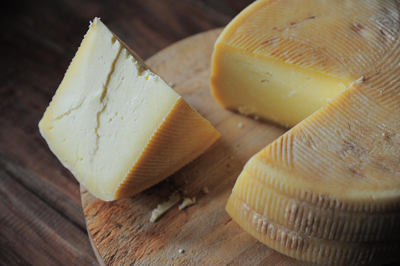 Gruyere cheese on a wooden cutting board