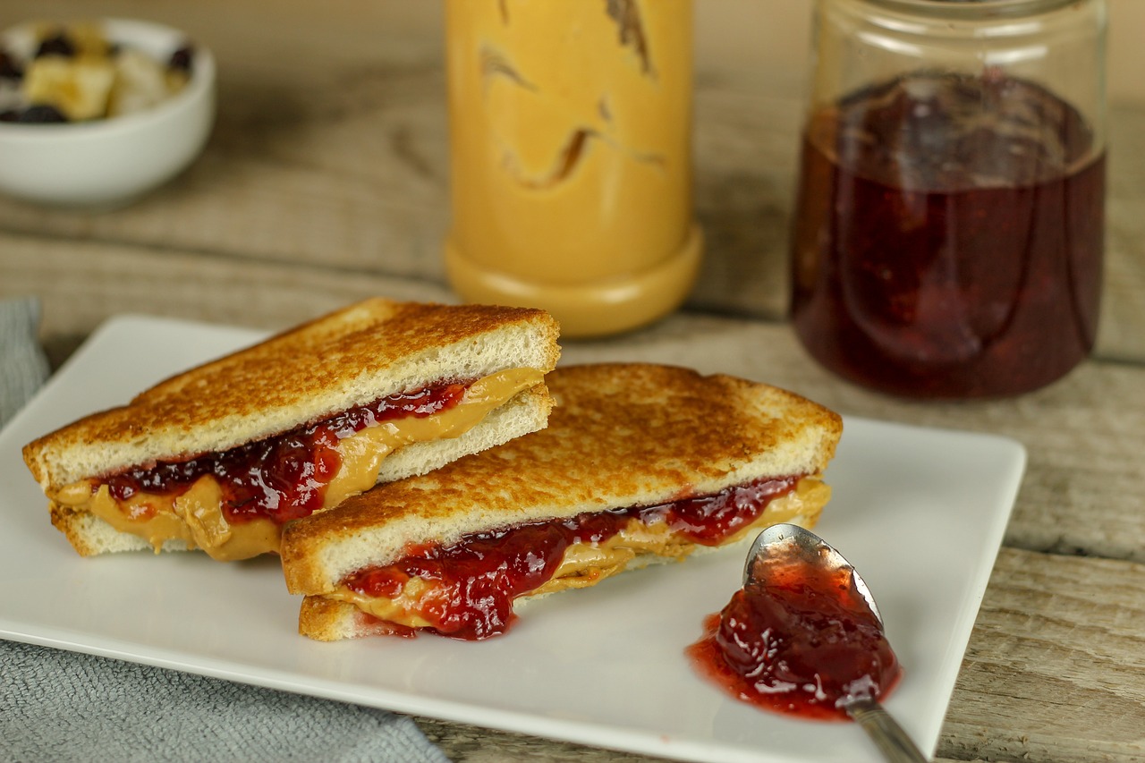 Peanut butter and jelly sandwich on a white plate