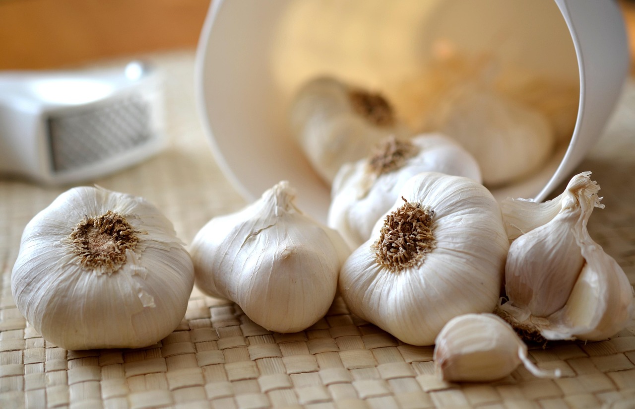Garlic cloves poured out of a white container