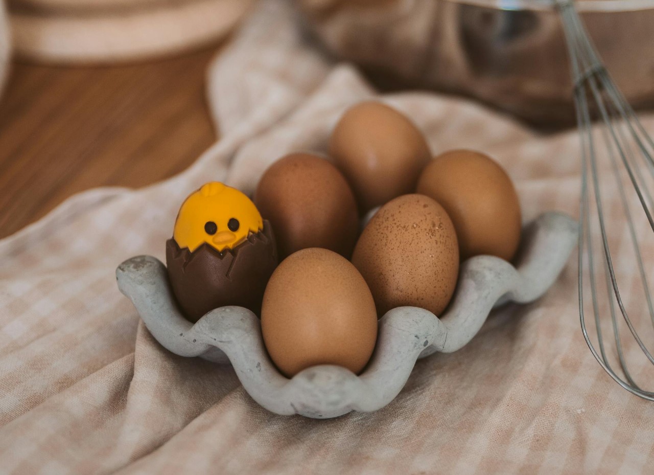 Yellow egg decoration hidden in one brown egg