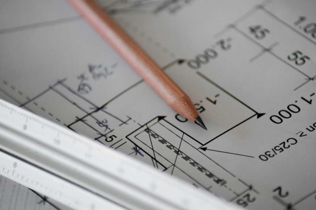 A blueprint is laid out with a pencil for taking notes