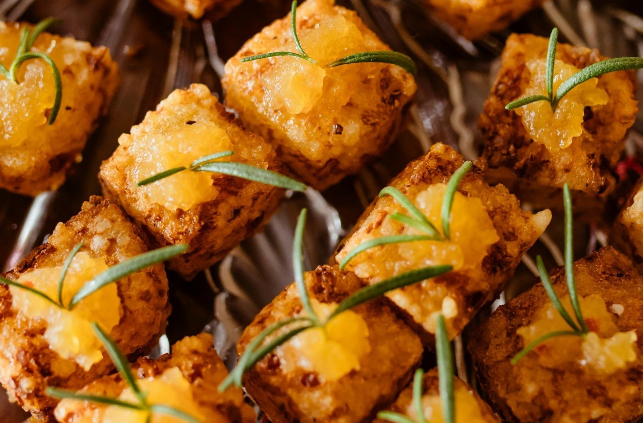 Fried tofu on a clear tray