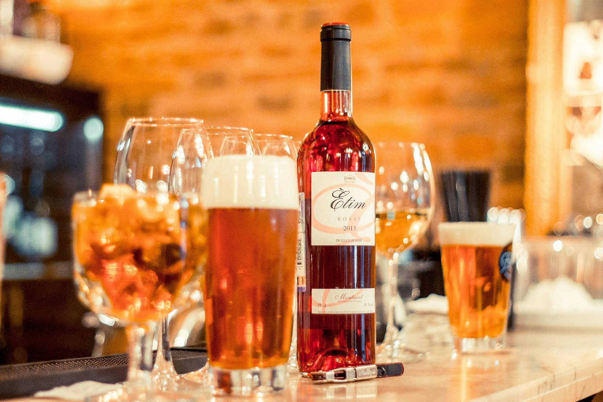 Wine glasses, beer and a bottle of wine