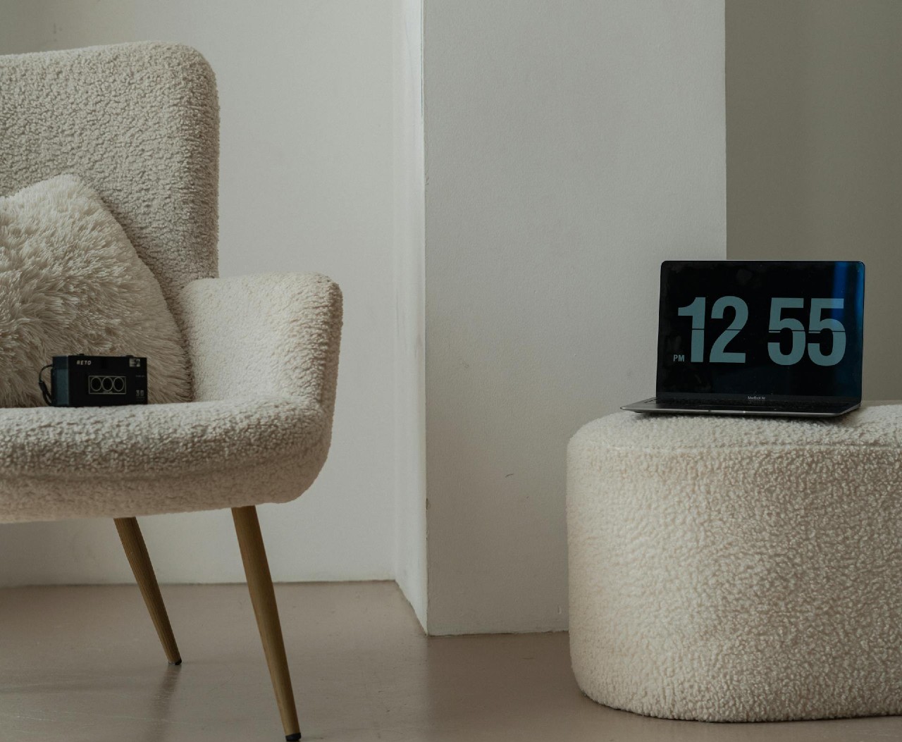 Chair and clock sitting on ottoman