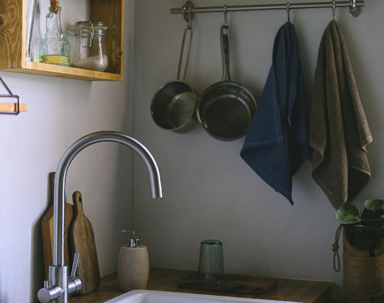 Kitchen towels hanging on rack by kitchen sink