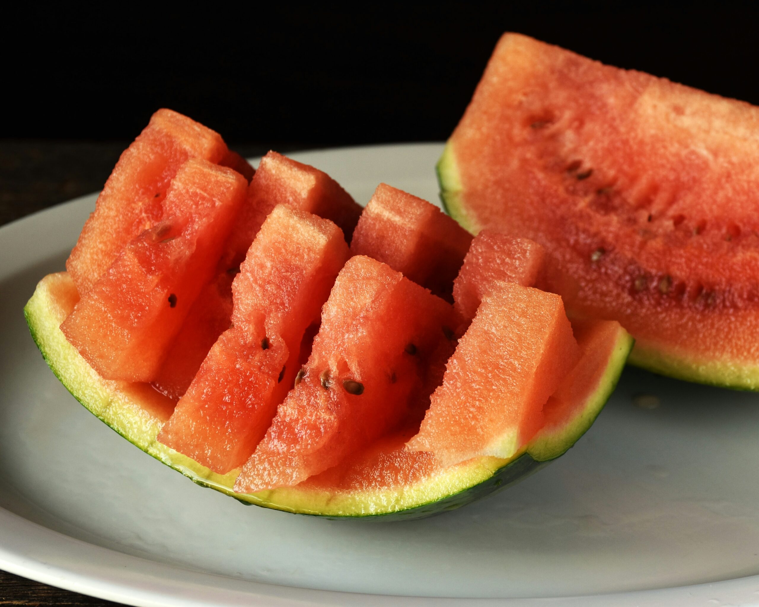 Watermelon slices on a white plate. Red white and blue watermelon salad. 